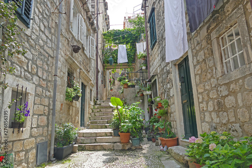 Historic street with stone houses clothes line and flowers, Dubrovnik, Croatia