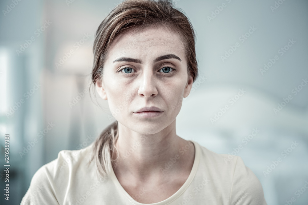 Fototapeta premium Portrait of tired female person that posing on camera