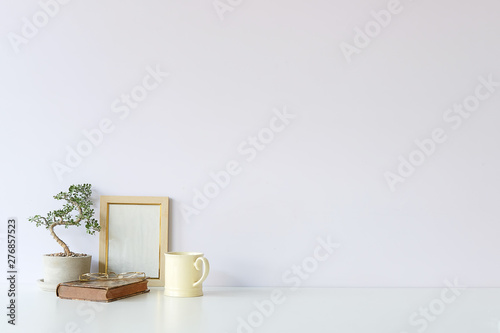 Fototapeta Naklejka Na Ścianę i Meble -  Mockup workspace desk and copy space books,plant and coffee on white desk.