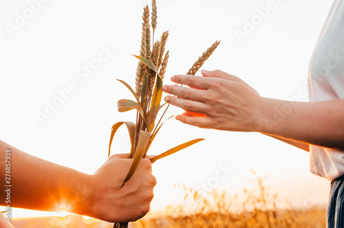 man giving a bouquet of wheat