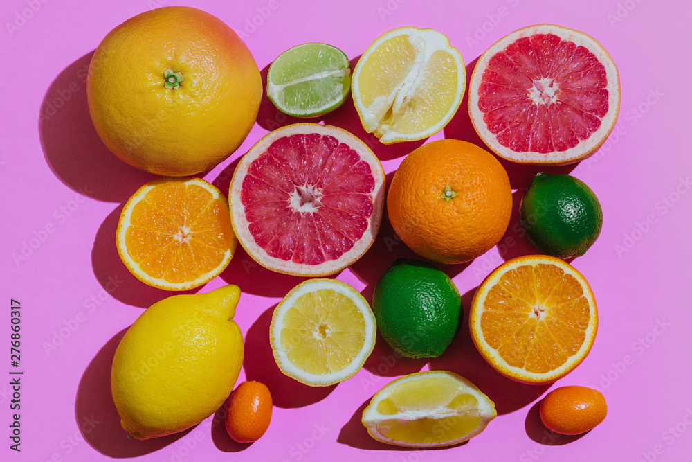 Citrus fruits fresh cutted on a pastel pink background grouped top view Citrus fruits fresh cutted on a pastel pink background grouped top view