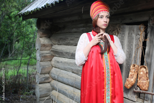 girl in traditional dress wooden wall