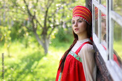 Slav woman in traditional dress wooden wall