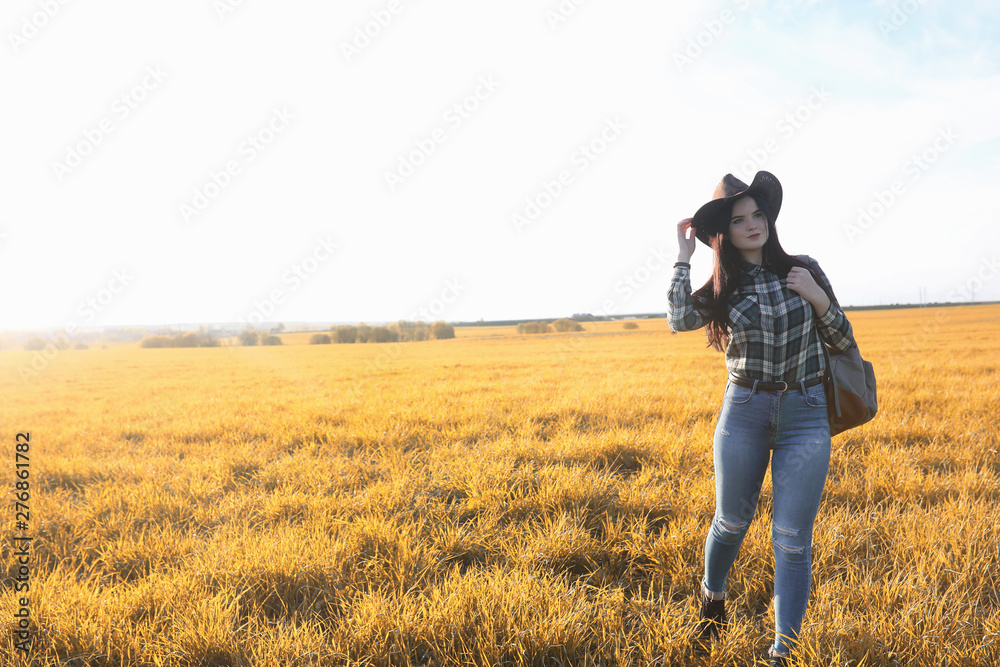 A young girl is traveling around the city hitchhiking. A beautiful young girl went on vacation. A female student in a cowboy hat on the road in autumn. A young girl is traveling around the city hitchhiking. A beautiful young girl went on vacation. A female student in a cowboy hat on the road in autumn.