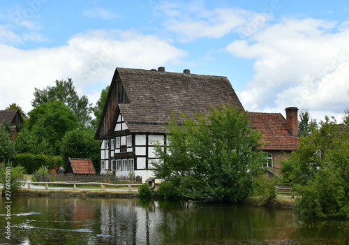 Country landscape. An old house on the bank of a quiet river.