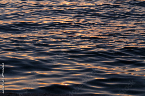 Sea waves in the rays of a sunset