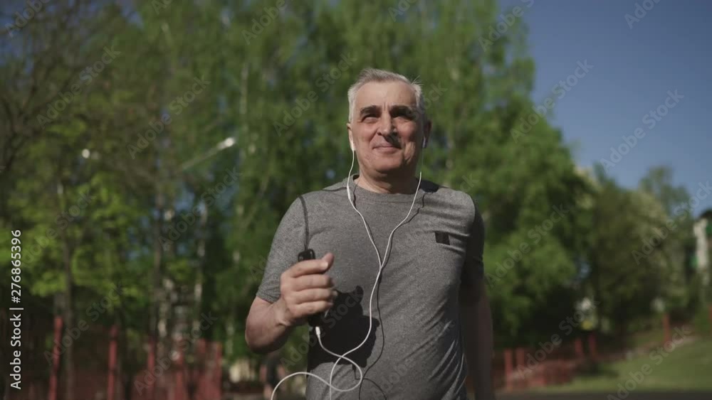 Senior seventy years old man jogging in the city Senior seventy years old man jogging in the city