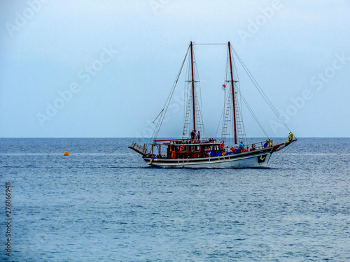 A lonely touristic boat on a calm blue sea