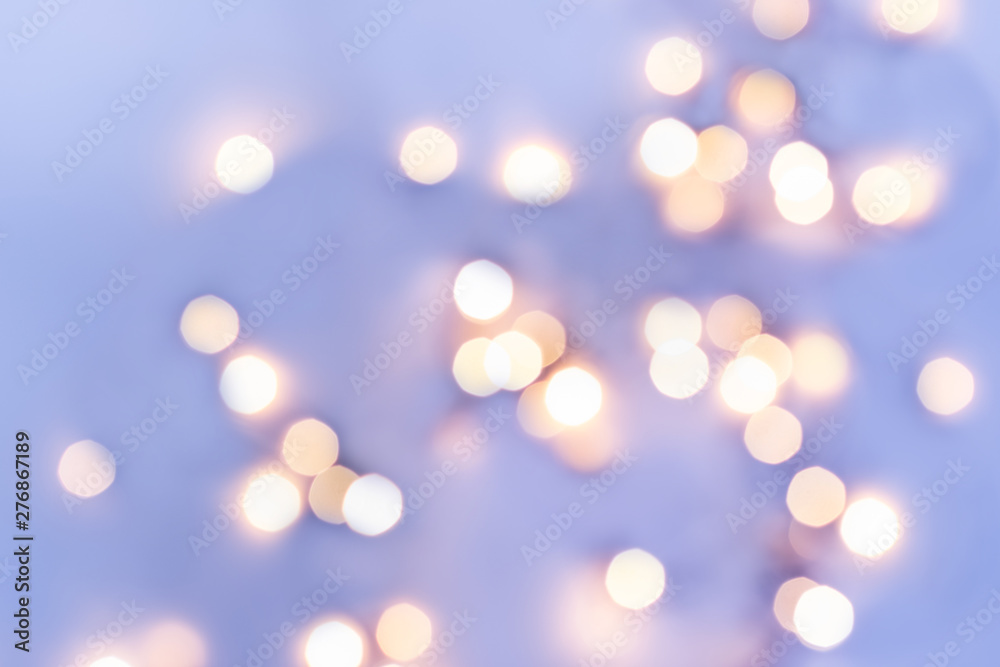 Obraz premium Golden festive bokeh lights on blue background. Christmas or party concept