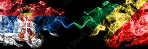 Serbia vs Congo, Congolese smoky mystic flags placed side by side. Thick colored silky smokes combination of Serbian and Congo, Congolese flag