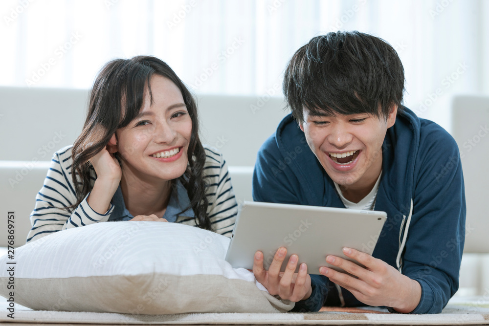 タブレットPCを見るカップル