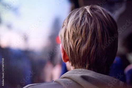 Young blonde adult looking at the sunset