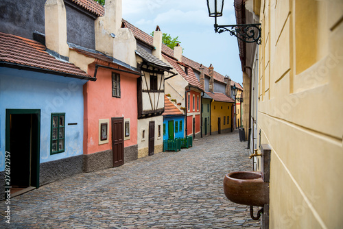 Fototapeta Naklejka Na Ścianę i Meble -  Cobblestone street and colorful 16th century cottages of artisans known as Golden Lane inside the castle walls Prague Czech Re