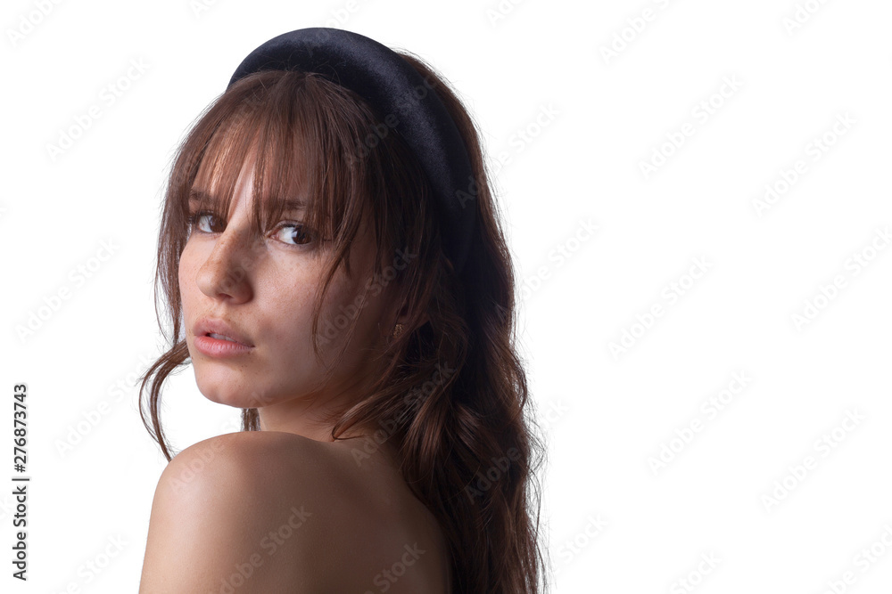 Fototapeta premium Close-up shot of a young caucasian girl with curly hair and bangs