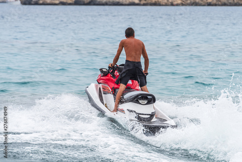 Man driving with a jet sky in the Mediterranean Sea in Cyprus