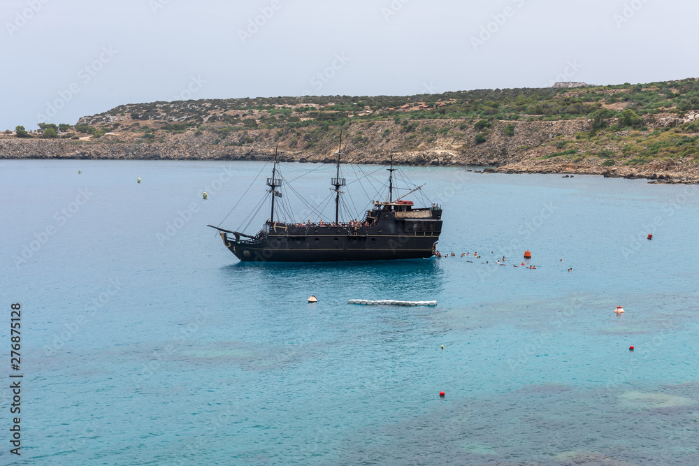 Fototapeta premium Touristic boat navigating in the Mediterranean Sea in Cyprus