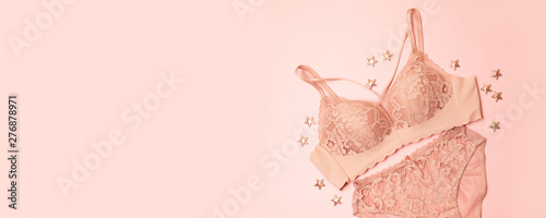 gently pink lace underwear with stars decor on a pink background. Congratulatory romantic concept for Valentine's Day photo