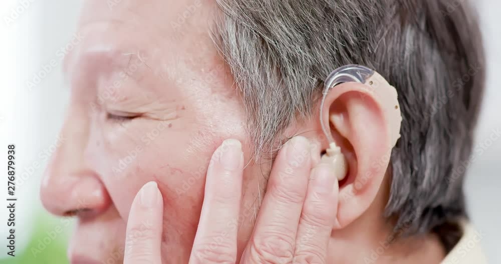 Doctor help patient wear audiphone Doctor help patient wear audiphone