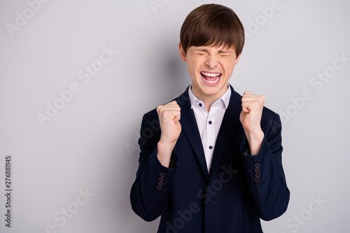 Portrait of ecstatic funny funky pupil close yes raise fists hands scream shout yeah have aims luck lucky dressed black jackets shirt isolated grey argent background photo