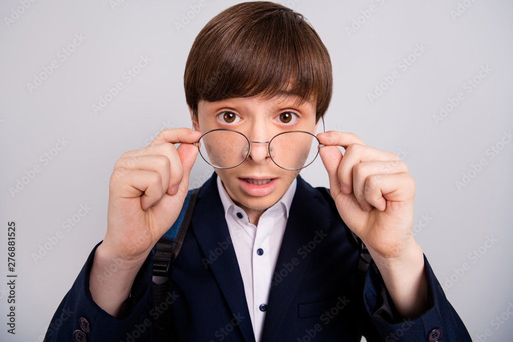 Close up photo of astonished boy touch round specs hear unbelievable horrible unexpected learning news dressed modern clothing white shirt isolated silver grey background information Close up photo of astonished boy touch round specs hear unbelievable horrible unexpected learning news dressed modern clothing white shirt isolated silver grey background information