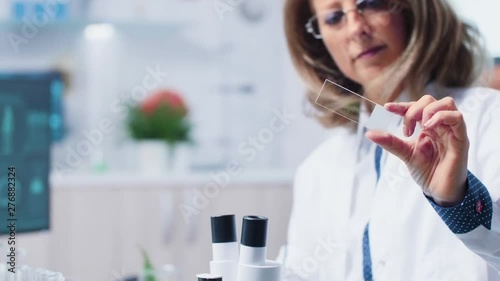 Close up of female biologist holding a bio sample in hands. Dolly shot