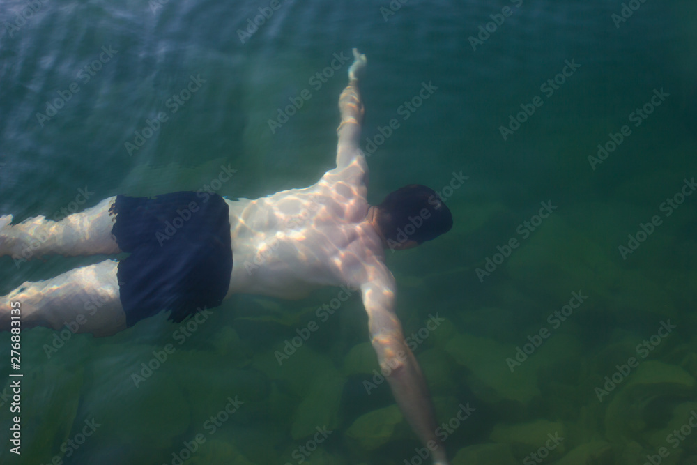 Male young swimmer underwater - sea, swimming lessons, diving