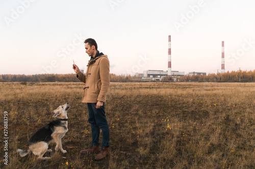Wallpaper Mural A man with a mongrel dog walking on autumn meadow Torontodigital.ca