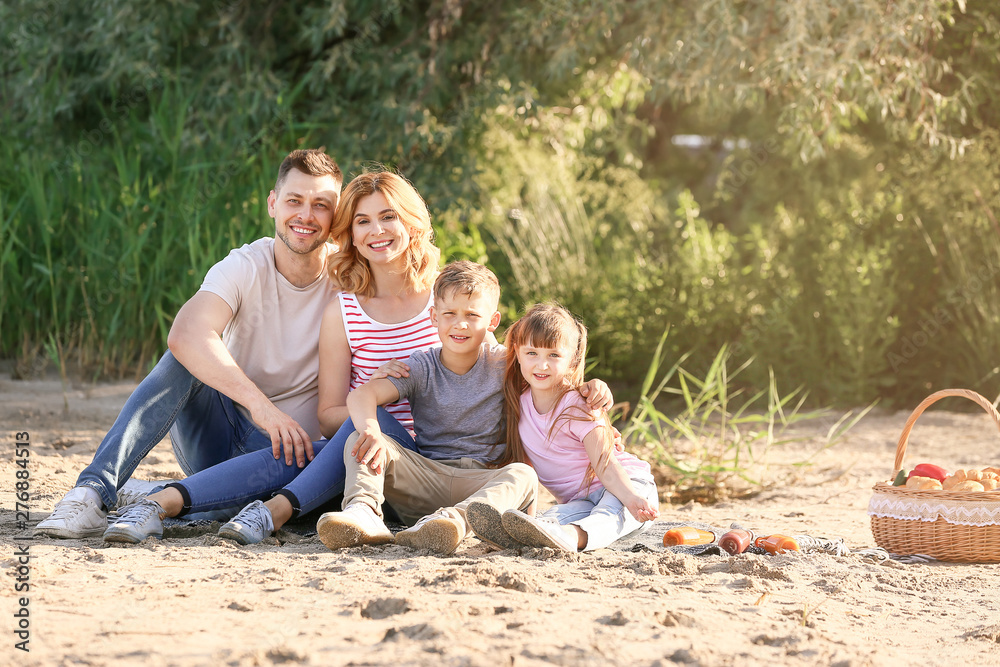 Fototapeta premium Happy family on summer picnic near river