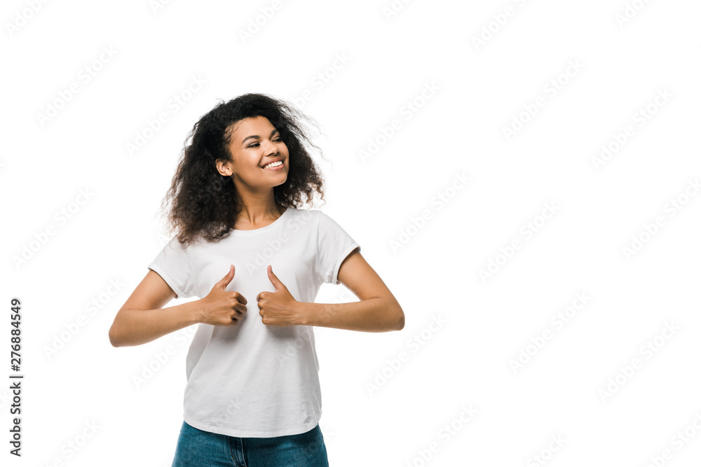 curly and positive african american woman showing thumbs up isolated on white curly and positive african american woman showing thumbs up isolated on white
