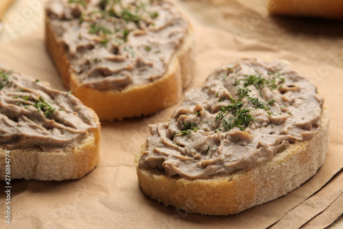 Fresh homemade chicken liver pate with herbs for bread on a natural wooden table. A sandwich. close-up