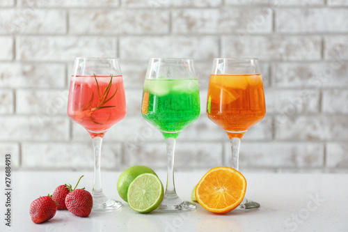 Glasses of tasty summer cocktails on table
