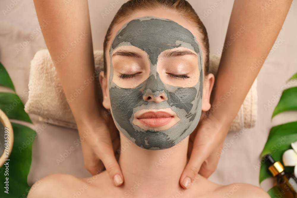 Fototapeta premium Beautiful young woman relaxing in spa salon, top view