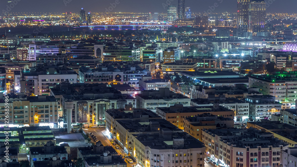 Aerial view of neighbourhood Deira with typical buildings night timelapse, Dubai, United Arab Emirates