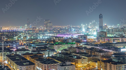 Aerial view of neighbourhood Deira with typical buildings night timelapse  Dubai  United Arab Emirates
