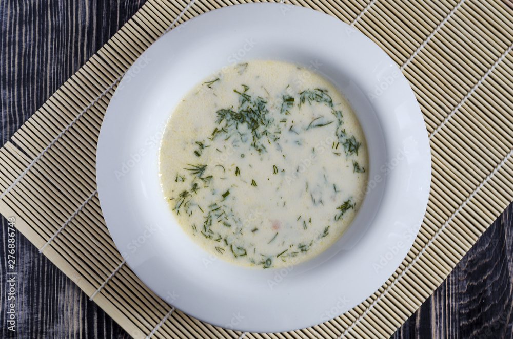 soup with vegetables and cheese in a white plate wooden background soup with vegetables and cheese in a white plate wooden background