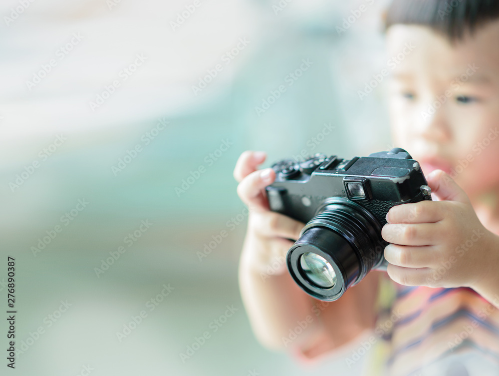 The little boy started training in photography. May be interested and think that it is just a toy. The little boy started training in photography. May be interested and think that it is just a toy.