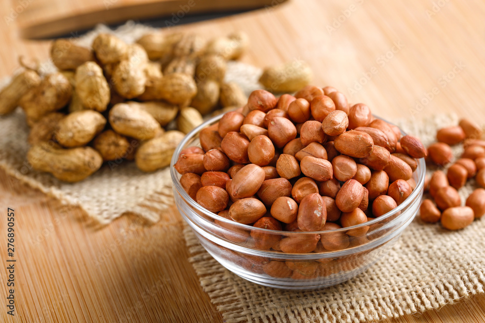 peanuts in bowl on the wooden background. peanuts in bowl on the wooden background.