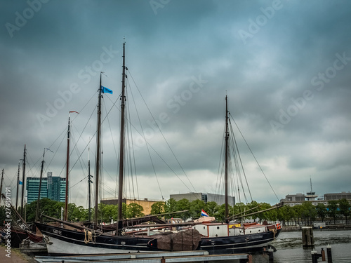 Harbor with yachts in Amsterdam, Netherlands with gray clouds photo