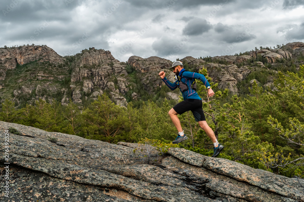Male runner running on a mountain trail