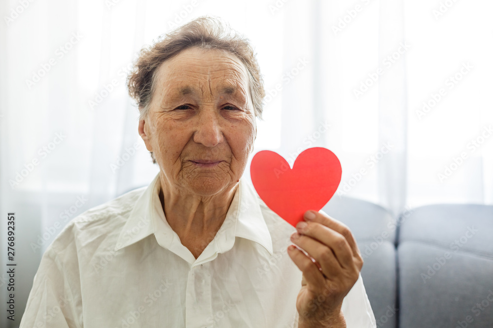 valentine's day, summer and old people concept - portrait of smiling senior woman with red heart valentine's day, summer and old people concept - portrait of smiling senior woman with red heart