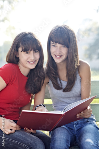 teenage girls holding books school education