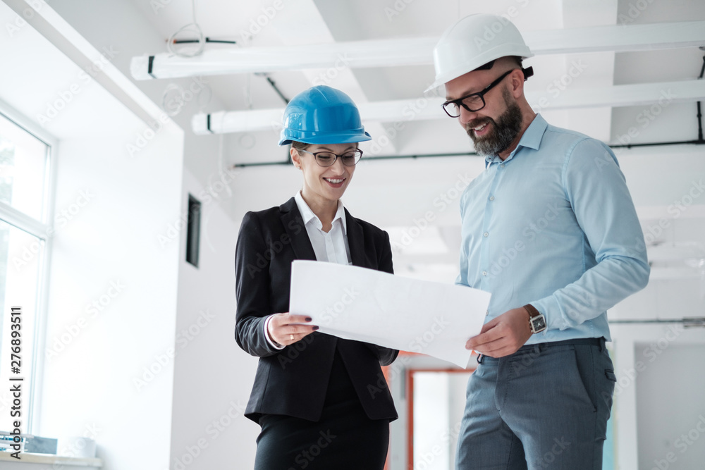 Engineers in hardhats have conversation Engineers in hardhats have conversation