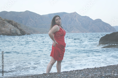 RED DRESS WOMAN AT THE BEACH POSING