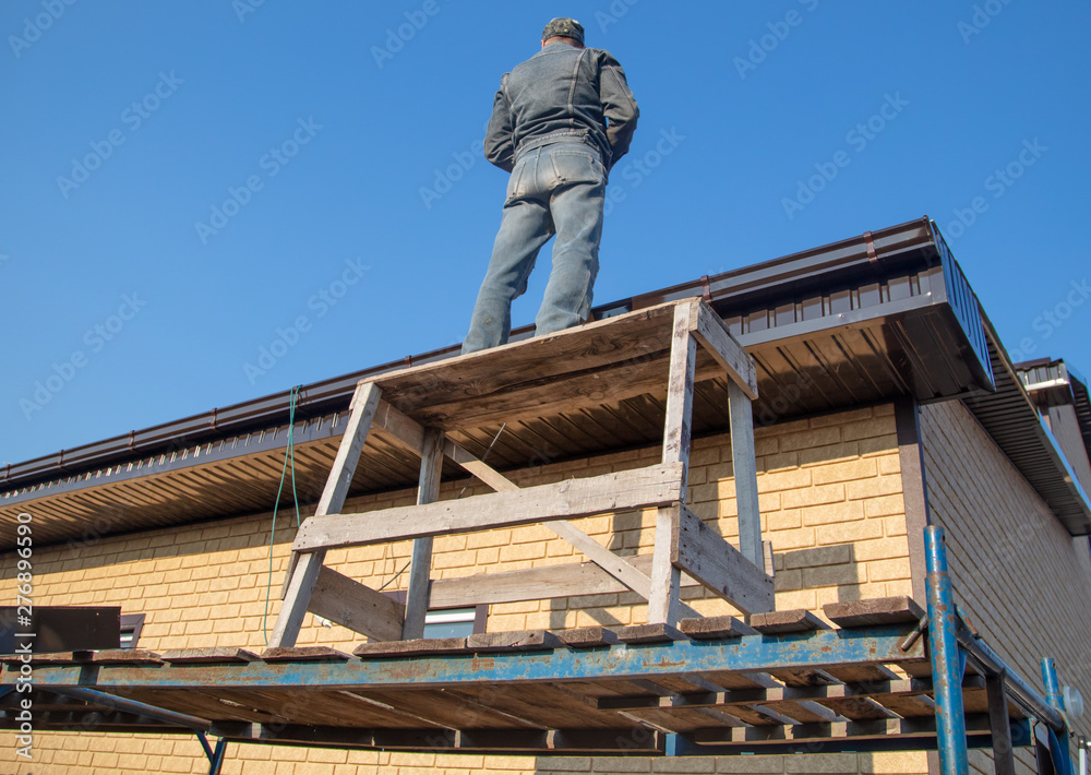Installation of metal drain on the roof of the house