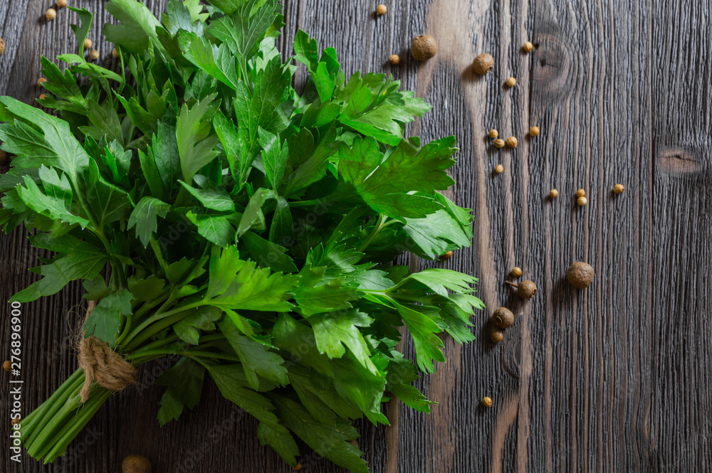 Bunch of fresh parsley and spices on dark wooden background. Bunch of fresh parsley and spices on dark wooden background.