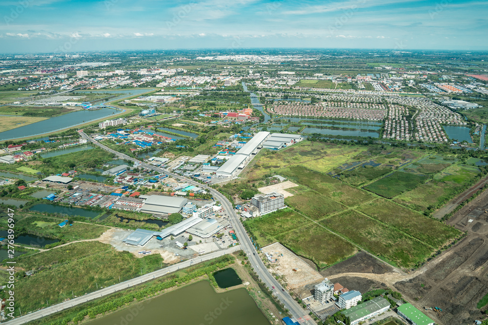 the view of green field and farm and city downtown in middle of Thailand. It shot from Jetplane.