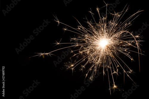 Small new year sparkler on black background.