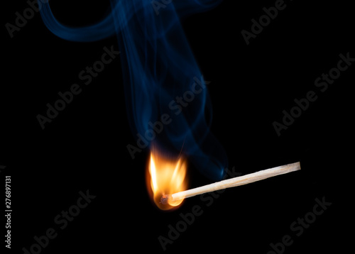 Wooden match with a sulfur head at the moment when it explodes.