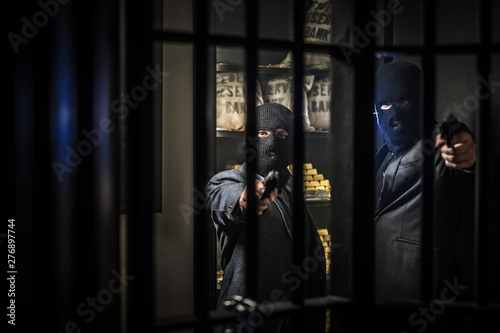 Two ardmed men robbing a bank
