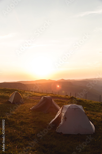 Camping tent in Mountains Morning sunrise orange Landscape Travel Lifestyle concept adventure vacations outdoor hiking gear equipment